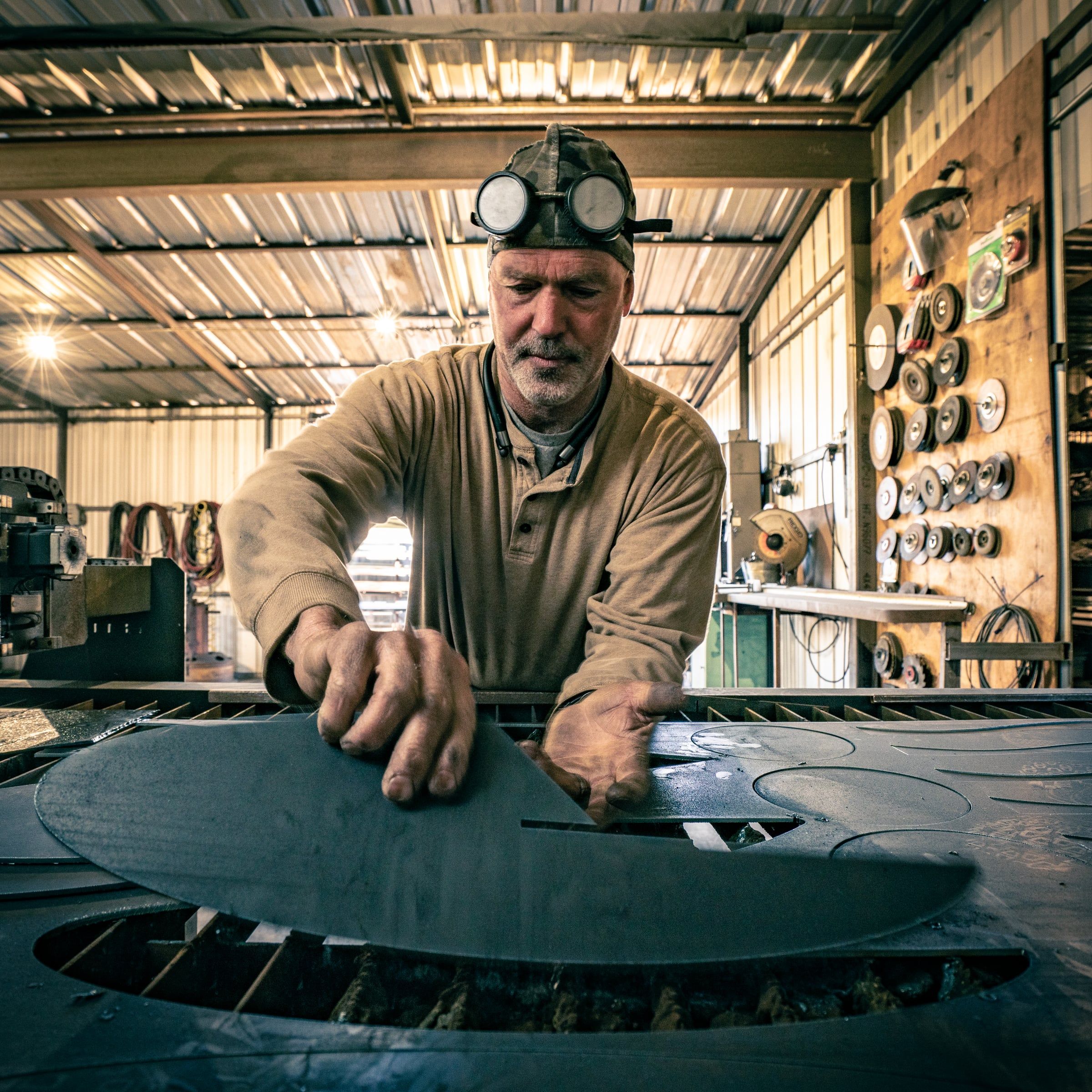 John T. Benedict at his cutting table in the studio